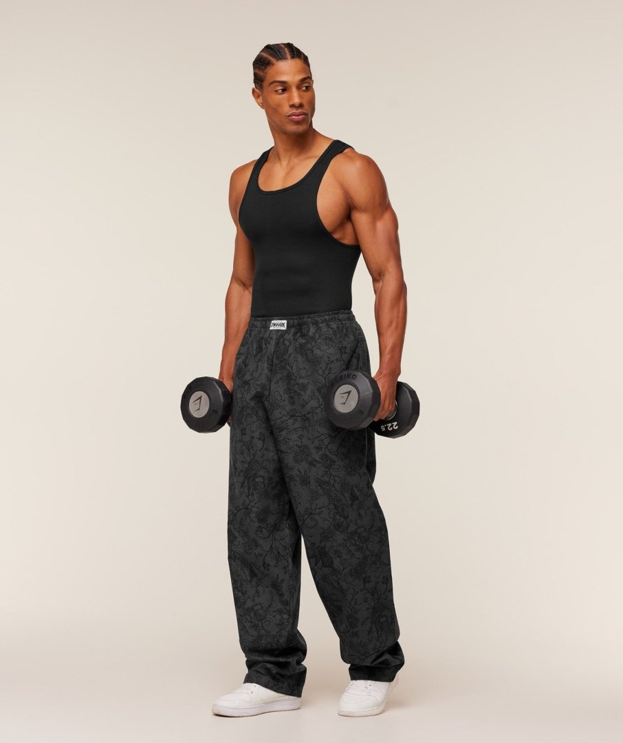 Homme portant le Gymshark Straight Leg Pumper Pants noir, vue de profil
